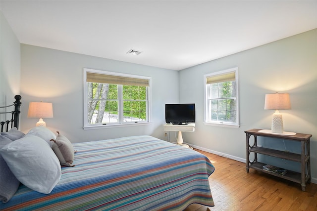 2 Shoshone Dr, Katonah, NY 10536 - bedroom with multiple windows, baseboards, and hardwood / wood-style floors