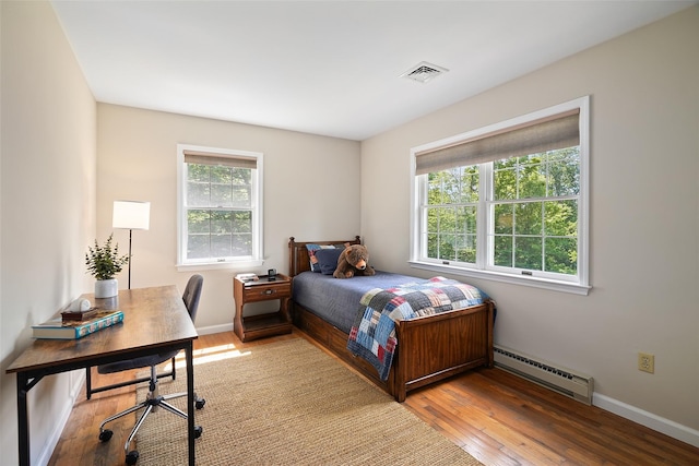 2 Shoshone Dr, Katonah, NY 10536 - bedroom featuring baseboard heating, wood-type flooring, baseboards, and an office area