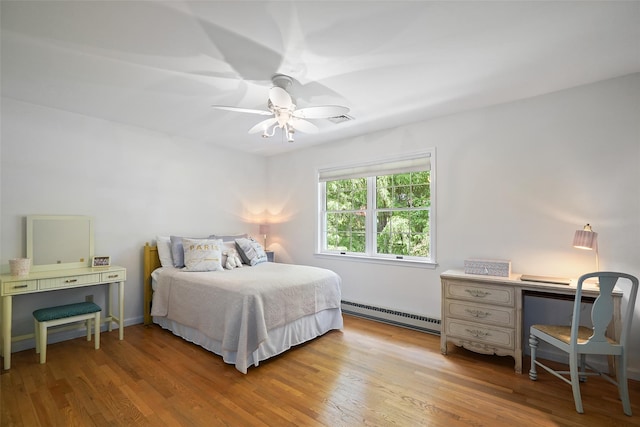 2 Shoshone Dr, Katonah, NY 10536 - bedroom with baseboard heating, light wood-type flooring, a ceiling fan, and an office area