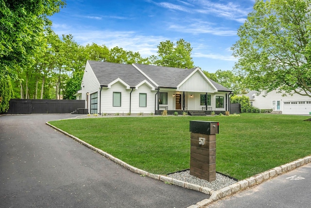 57 Varsity Blvd, East Setauket, NY 11733 - ranch-style home with a porch, roof with shingles, asphalt driveway, and a garage