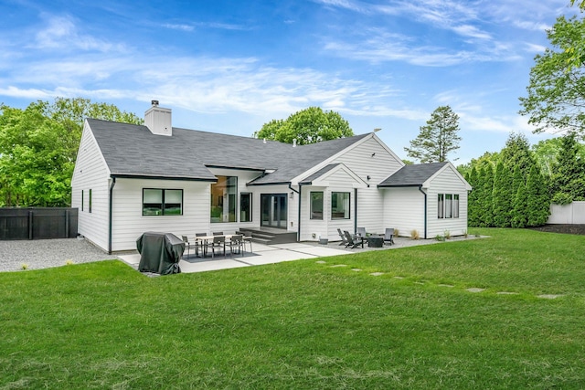 57 Varsity Blvd, East Setauket, NY 11733 - back of property with a chimney, a patio, and roof with shingles