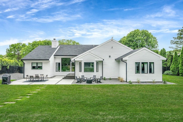 57 Varsity Blvd, East Setauket, NY 11733 - back of property with a chimney, a patio, and roof with shingles