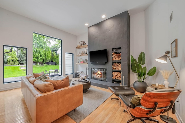 57 Varsity Blvd, East Setauket, NY 11733 - living area featuring light wood-type flooring, plenty of natural light, recessed lighting, and a large fireplace
