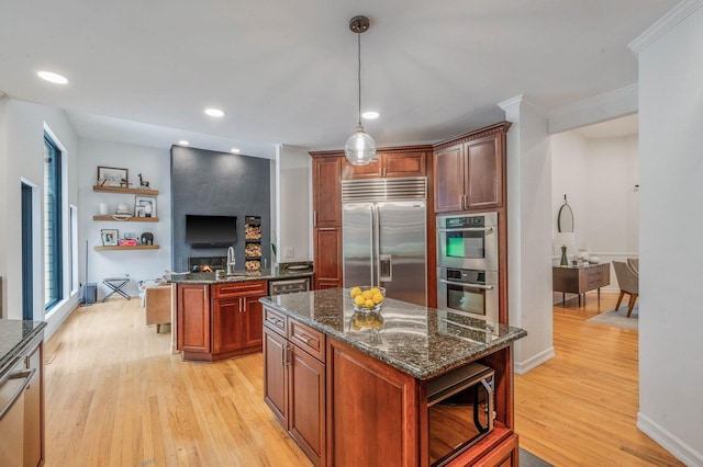 57 Varsity Blvd, East Setauket, NY 11733 - kitchen with stainless steel appliances, light wood finished floors, a center island, open shelves, and recessed lighting