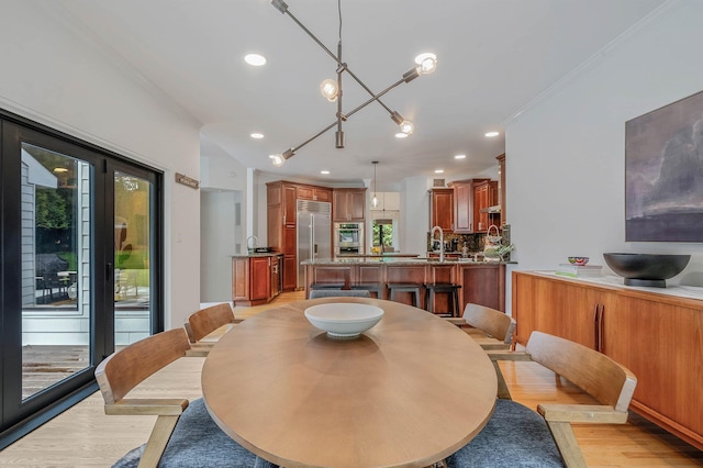 57 Varsity Blvd, East Setauket, NY 11733 - dining area with light wood-style flooring, recessed lighting, healthy amount of natural light, and crown molding