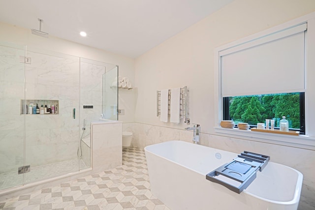 57 Varsity Blvd, East Setauket, NY 11733 - bathroom featuring a marble finish shower, a freestanding bath, tile walls, a wainscoted wall, and recessed lighting