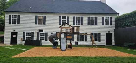 57 Varsity Blvd, East Setauket, NY 11733 - rear view of property featuring a playground, a lawn, and a chimney