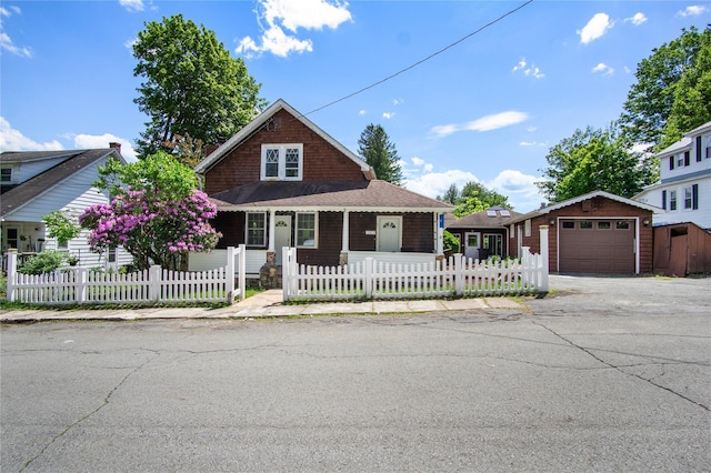 7 Lake St, Monticello, NY 12701 - view of front of property featuring a fenced front yard, a porch, asphalt driveway, and roof with shingles
