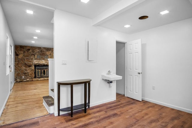 7 Lake St, Monticello, NY 12701 - bathroom with wood finished floors, a stone fireplace, and baseboards