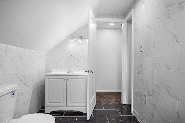 7 Lake St, Monticello, NY 12701 - bathroom featuring tile walls, vanity, and toilet