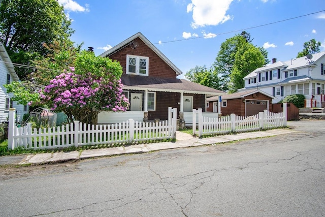 7 Lake St, Monticello, NY 12701 - view of front of house featuring a garage, concrete driveway, a fenced front yard, and a porch