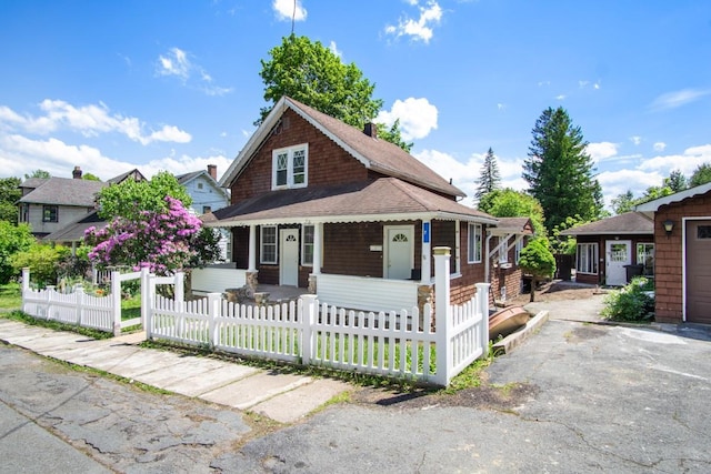 7 Lake St, Monticello, NY 12701 - view of front facade featuring a porch, a fenced front yard, and roof with shingles