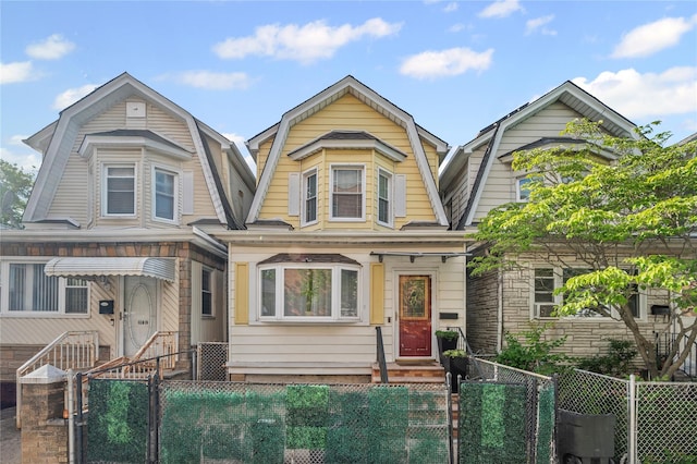 102-13 85th Ave, Richmond Hill, NY 11418 - dutch colonial featuring a gambrel roof, a fenced front yard, entry steps, and a gate