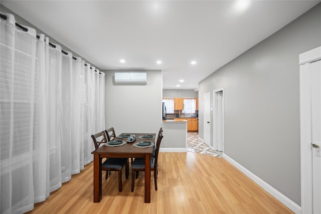 102-13 85th Ave, Richmond Hill, NY 11418 - dining area with a wall unit AC, light wood finished floors, recessed lighting, and baseboards