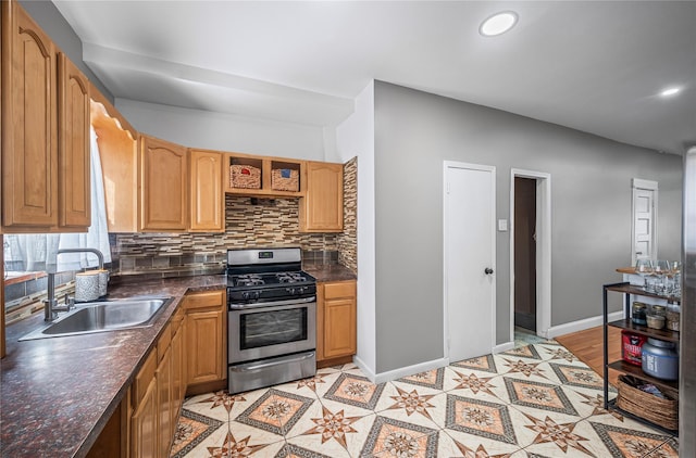 102-13 85th Ave, Richmond Hill, NY 11418 - kitchen with stainless steel range with gas cooktop, a sink, decorative backsplash, dark countertops, and recessed lighting