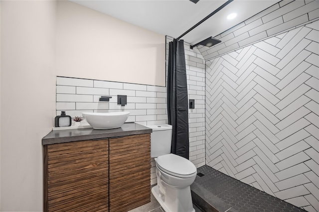 102-13 85th Ave, Richmond Hill, NY 11418 - bathroom with a tile shower, toilet, vanity, tile walls, and wainscoting