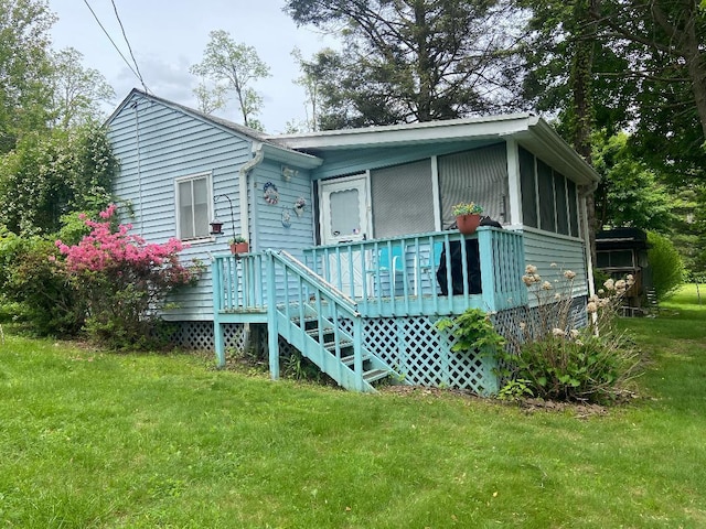 191 Sylvan Lake Rd Unit 5, Hopewell Junction, NY 12533 - view of front of house with a front lawn, a sunroom, and a deck