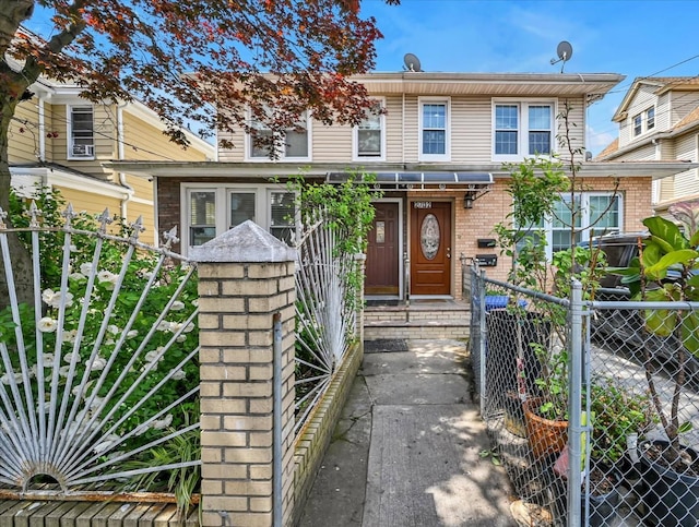 27-34 Mcintosh St, East Elmhurst, NY 11369 - view of front facade with a gate and brick siding