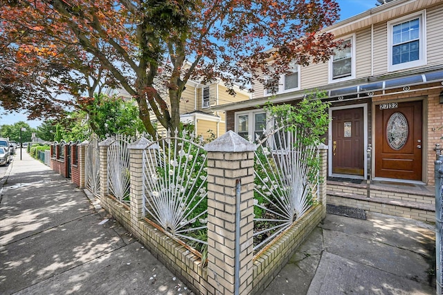 27-34 Mcintosh St, East Elmhurst, NY 11369 - view of exterior entry with brick siding and a gate