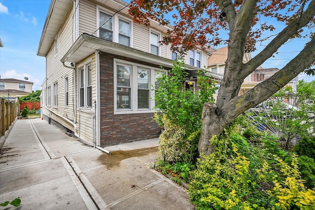 27-34 Mcintosh St, East Elmhurst, NY 11369 - view of side of home with brick siding