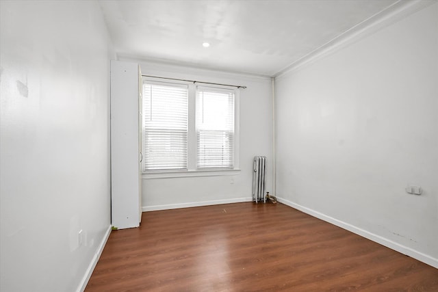 27-34 Mcintosh St, East Elmhurst, NY 11369 - unfurnished room featuring radiator, baseboards, and wood finished floors