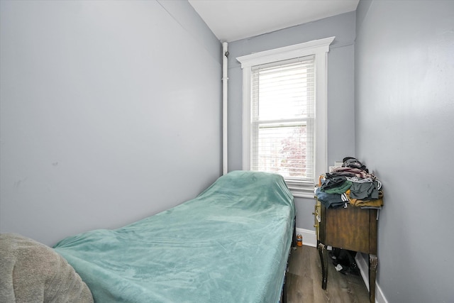 27-34 Mcintosh St, East Elmhurst, NY 11369 - bedroom featuring wood finished floors, multiple windows, and baseboards