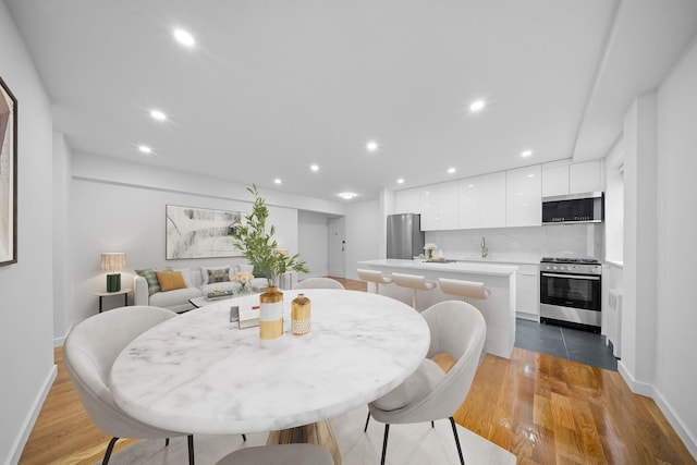 25-10 31st Ave Unit 2M, Astoria, NY 11106 - dining area with wood finished floors, baseboards, and recessed lighting