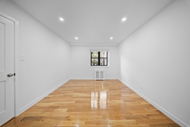 25-10 31st Ave Unit 2M, Astoria, NY 11106 - unfurnished room featuring light wood-style flooring, recessed lighting, radiator heating unit, and baseboards