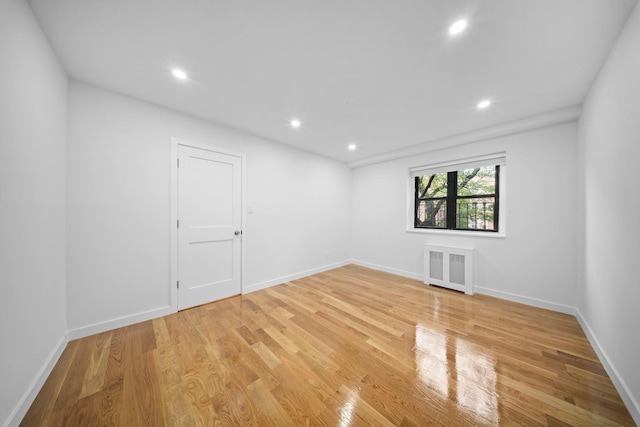 25-10 31st Ave Unit 2M, Astoria, NY 11106 - spare room featuring radiator heating unit, light wood finished floors, baseboards, and recessed lighting