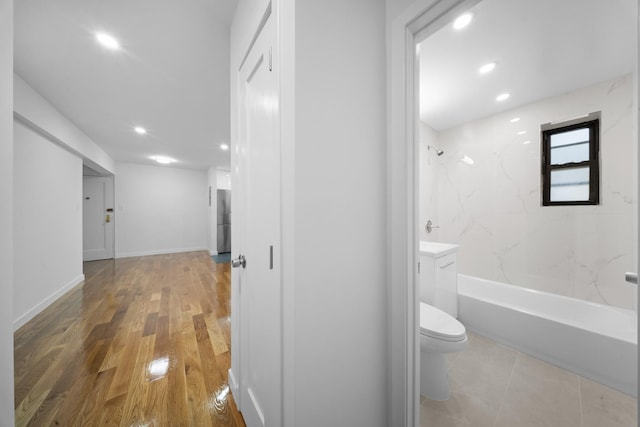 25-10 31st Ave Unit 2M, Astoria, NY 11106 - full bathroom with toilet, bathing tub / shower combination, recessed lighting, wood finished floors, and baseboards