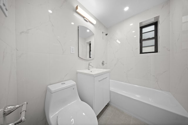 25-10 31st Ave Unit 2M, Astoria, NY 11106 - full bathroom featuring vanity, toilet, shower / washtub combination, and tile walls