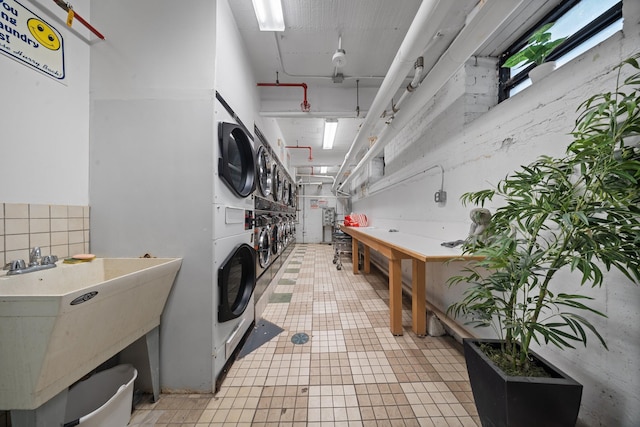 25-10 31st Ave Unit 2M, Astoria, NY 11106 - washroom with a sink and estacked washer and dryer