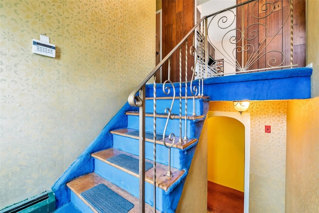 65 Cedar Ct, Copiague, NY 11726 - stairway featuring wallpapered walls and arched walkways