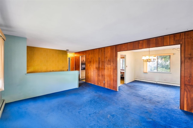 65 Cedar Ct, Copiague, NY 11726 - unfurnished living room featuring a baseboard heating unit, a chandelier, carpet, and wooden walls