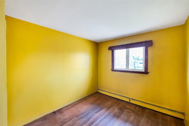 65 Cedar Ct, Copiague, NY 11726 - unfurnished room featuring baseboard heating and dark wood-style flooring
