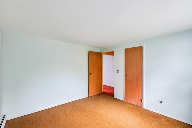 65 Cedar Ct, Copiague, NY 11726 - unfurnished bedroom with baseboard heating, a closet, and light colored carpet