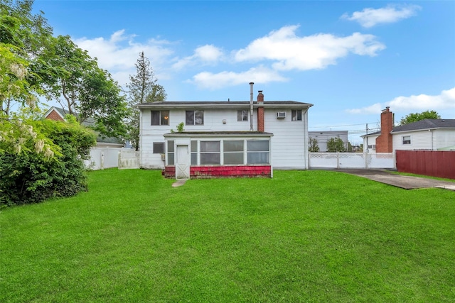 65 Cedar Ct, Copiague, NY 11726 - back of property featuring a sunroom and a chimney