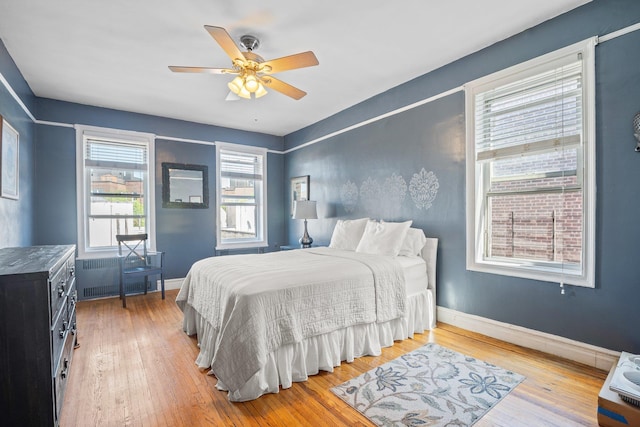 35-05 72nd St Unit 6F, Jackson Heights, NY 11372 - bedroom featuring radiator, baseboards, and light wood-type flooring