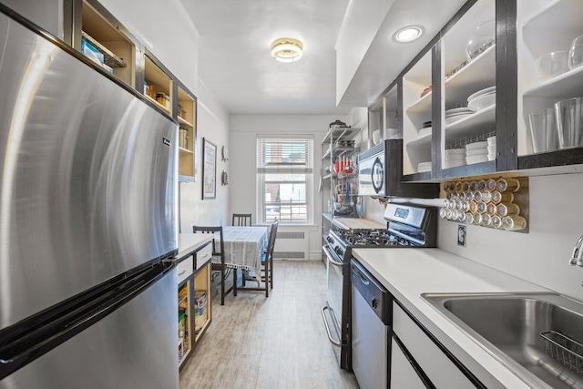 35-05 72nd St Unit 6F, Jackson Heights, NY 11372 - kitchen featuring stainless steel appliances, a sink, radiator heating unit, and open shelves