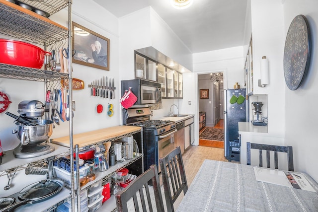 35-05 72nd St Unit 6F, Jackson Heights, NY 11372 - kitchen featuring appliances with stainless steel finishes, light wood finished floors, and a sink