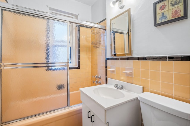 35-05 72nd St Unit 6F, Jackson Heights, NY 11372 - bathroom featuring tile walls, toilet, shower / bath combination with glass door, and vanity