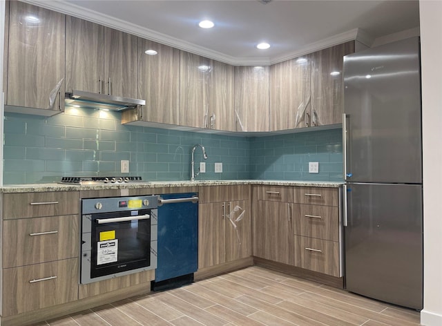132-27 41st Rd Unit 7E, Flushing, NY 11355 - kitchen with appliances with stainless steel finishes, under cabinet range hood, modern cabinets, a sink, and light stone counters