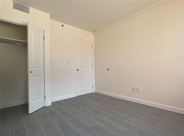 132-27 41st Rd Unit 7E, Flushing, NY 11355 - unfurnished bedroom featuring dark wood-style floors, baseboards, ornamental molding, and a closet