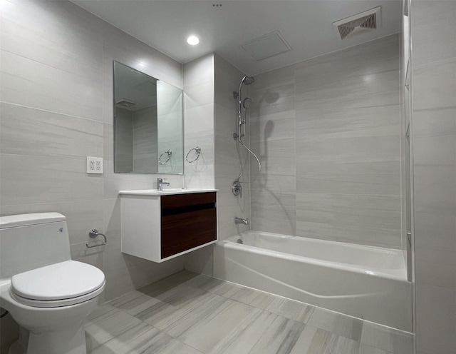 132-27 41st Rd Unit 7E, Flushing, NY 11355 - full bath featuring bathing tub / shower combination, toilet, tile patterned flooring, vanity, and tile walls