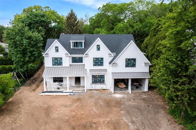 6 Dorchester Ln, Call Listing Agent, CT 06878 - modern farmhouse with a standing seam roof, a porch, metal roof, roof with shingles, and dirt driveway