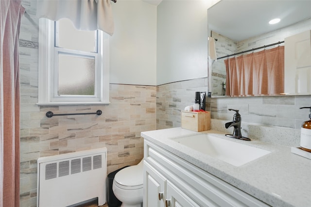 223 Schrade Rd Unit 2C, Briarcliff Manor, NY 10510 - bathroom with radiator, vanity, toilet, tile walls, and curtained shower
