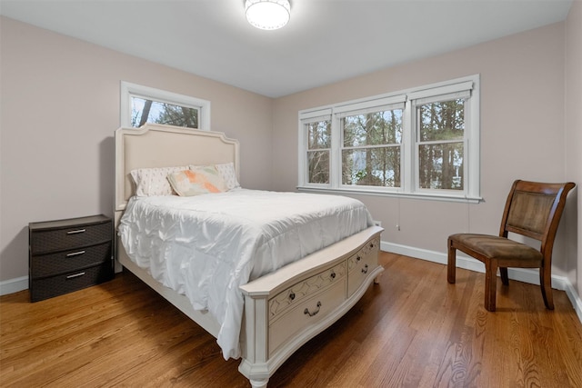 6 Ogden Rd, Scarsdale, NY 10583 - bedroom with multiple windows, baseboards, and light wood-style flooring