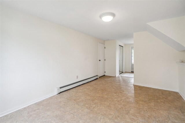 6 Poppy Dr, Massapequa Park, NY 11762 - spare room featuring a baseboard heating unit, baseboards, and light stone finish floors