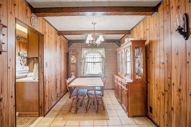 2010 27th St, Astoria, NY 11105 - dining space featuring a chandelier, beam ceiling, wooden walls, light tile patterned floors, and brick wall