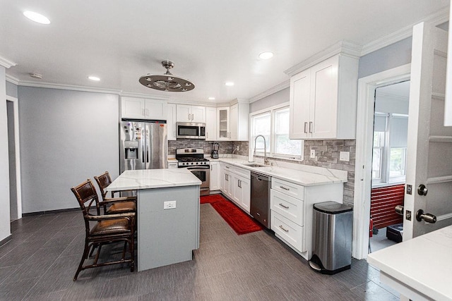426 N High St, Mount Vernon, NY 10552 - kitchen with stainless steel appliances, a sink, crown molding, backsplash, and a center island